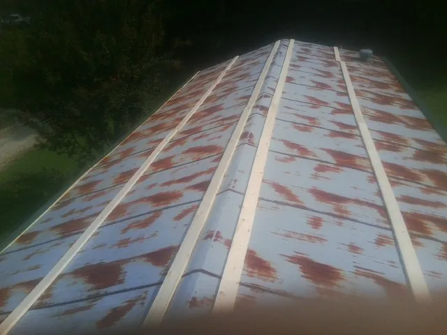 Rusted metal roof panels with new wood purlins before replacement — Storm Damage Roof Repair in Bidwell by Roofing Brothers